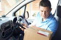 Courier In Van Delivering Package To Domestic House Royalty Free Stock Photo