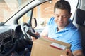 Courier In Van Delivering Package To Domestic House Royalty Free Stock Photo