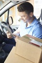 Courier In Van With Digital Tablet Delivering Package To Domestic House Royalty Free Stock Photo