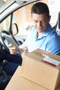 Courier In Van With Digital Tablet Delivering Package To Domestic House Royalty Free Stock Photo