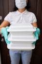 Courier woman hold go box food, delivery service, Takeaway restaurants food delivery to home door, Stay at home safe lives from co Royalty Free Stock Photo