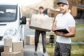 Couriers delivering parcels by car Royalty Free Stock Photo