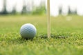 Course Golf ball cub on the green near hole for Family day. Royalty Free Stock Photo