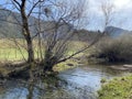 The course of the river Orbe between the cave or spring and the settlement of Vallorbe der Fluss Orbe or le fleuve de l`Orbe Royalty Free Stock Photo