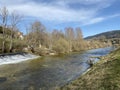 The course of the river Orbe between the cave or spring and the settlement of Vallorbe der Fluss Orbe or le fleuve de l`Orbe Royalty Free Stock Photo