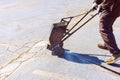 In course of worker patching patcher performs coated crack filling asphalt crack sealing bitumen emulsion road