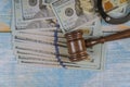 Court gavel and money on blue background