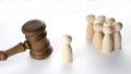 Court and law concept. Many wooden figures people and judge gavel Royalty Free Stock Photo