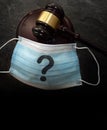 Court legal gavel and facemask with question mark -- Coronavirus mask mandate concept