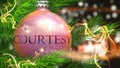 Courtesy and Christmas holidays, pictured as a Christmas ornament ball with word Courtesy and magic beams to symbolize the