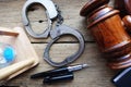 Courthouse verdict concept with justice objects as judge gavel and handcuffs on wooden desk