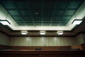 a courtroom witness box empty under ceiling lights