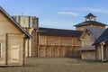 Courtyard of an ancient reconstructed wooden fortress with high walls and towers