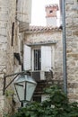 courtyard in Budva Old Town and stone wall with closed wooden sh Royalty Free Stock Photo