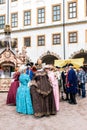 Courtyard of the castle, ladies and gentlemen in the costumes of