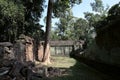The courtyard of the dilapidated temple complex in Indochina. Ancient ruins in the forest Royalty Free Stock Photo