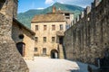 Courtyard and entrance Castello di Montebello castle with building and wall and mountain in background in Bellinzona Switzerland