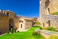 Courtyard with green grass lawn of Prima Torre Guaita first medieval tower with stone brick fortress wall, Republic San Marino Royalty Free Stock Photo