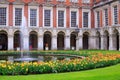 The Courtyard at Hampton Court full of yellow tulips which are surrounding a small fountain