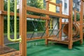 A courtyard of high-rise buildings with a modern and large playground made of wood and plastic on a rainy summer day without Royalty Free Stock Photo