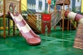 A courtyard of high-rise buildings with a modern and large playground made of wood and plastic on a rainy summer day without Royalty Free Stock Photo