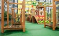 A courtyard of high-rise buildings with a modern and large playground made of wood and plastic on a rainy summer day without Royalty Free Stock Photo