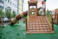 A courtyard of high-rise buildings with a modern and large playground made of wood and plastic on a rainy summer day without Royalty Free Stock Photo