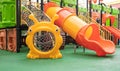 A courtyard of high-rise buildings with a new modern colorful and large playground on a rainy summer day without people. Empty Royalty Free Stock Photo