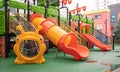 A courtyard of high-rise buildings with a new modern colorful and large playground on a rainy summer day without people. Empty Royalty Free Stock Photo