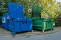 the courtyard of a hospital there are two garbage compactors next to each other, one for garbage, the other for paper and Royalty Free Stock Photo