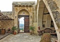 The courtyard of the house is paved with stone.