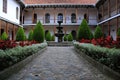 Courtyard interior, with balconies and a fontain in the middle, lush and perfectly symmetrical plaza