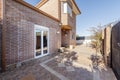 Courtyard of the main entrance a detached house with a mud brick facade with hedges and perimeter fencing Royalty Free Stock Photo