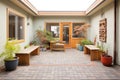 courtyard with mismatched paving and asymmetric planters