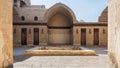Courtyard of mosque of Sultan Al Nassir Qalawun with side arched iwan and wooden doors, Cairo, Egypt
