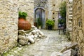 Courtyard in a mountain village in Cyprus with huge old terracotta amphora pot used as a flower pot