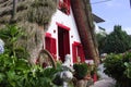 Courtyard of an old traditional house in Santana Madeira Island with red windows and a thatched roof Portugal Royalty Free Stock Photo