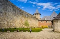 Courtyard and part of the wall of old castle Hotel near the river. Khotyn Fortress - medieval castle on yellow autumn hills.