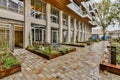 a courtyard with patio furniture in front of a building Royalty Free Stock Photo