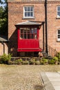 Courtyard with redbrick house and iron steps leading to a red po Royalty Free Stock Photo