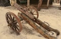 Antique brass cannon with wooden carriage and wheels Royalty Free Stock Photo