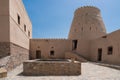 Courtyard of a small medieval arabian fort in Bukha, Oman. Windows, doors and round tower.