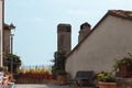 A courtyard in a terrace with plants, a bench and a lamppost on a sunny day Pesaro, Italy