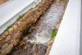 Courtyard water stream in Stellenbosch. Water gently flowing in a narrow stone moat.