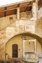 Courtyard with a well and fresco paintings in Italy