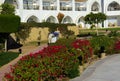 The courtyards of a magnificent white hotel on a summer day. The concept of tourism, vacations and luxury recreation.