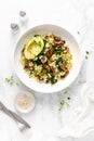 Couscous with avocado, spinach and sauteed champignon mushrooms with onion