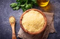 Couscous grain in wooden bowl