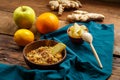 Couscous masfouf with dried fruits and nuts in a plate on a blue napkin on a wooden table next to fresh fruits.