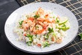 Couscous with roasted shrimps, tomatoes, red onions, almond nuts and parsley. Royalty Free Stock Photo